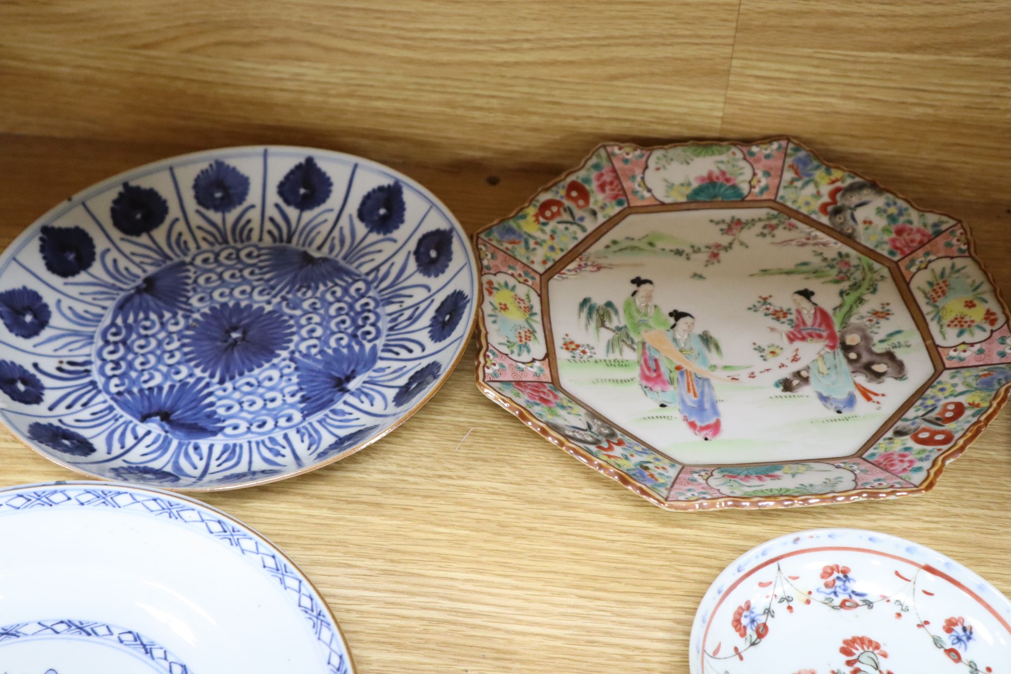 A collection of mostly 18th century Chinese export plates and dishes, a Chinese famille rose dish and another similar smaller dish
